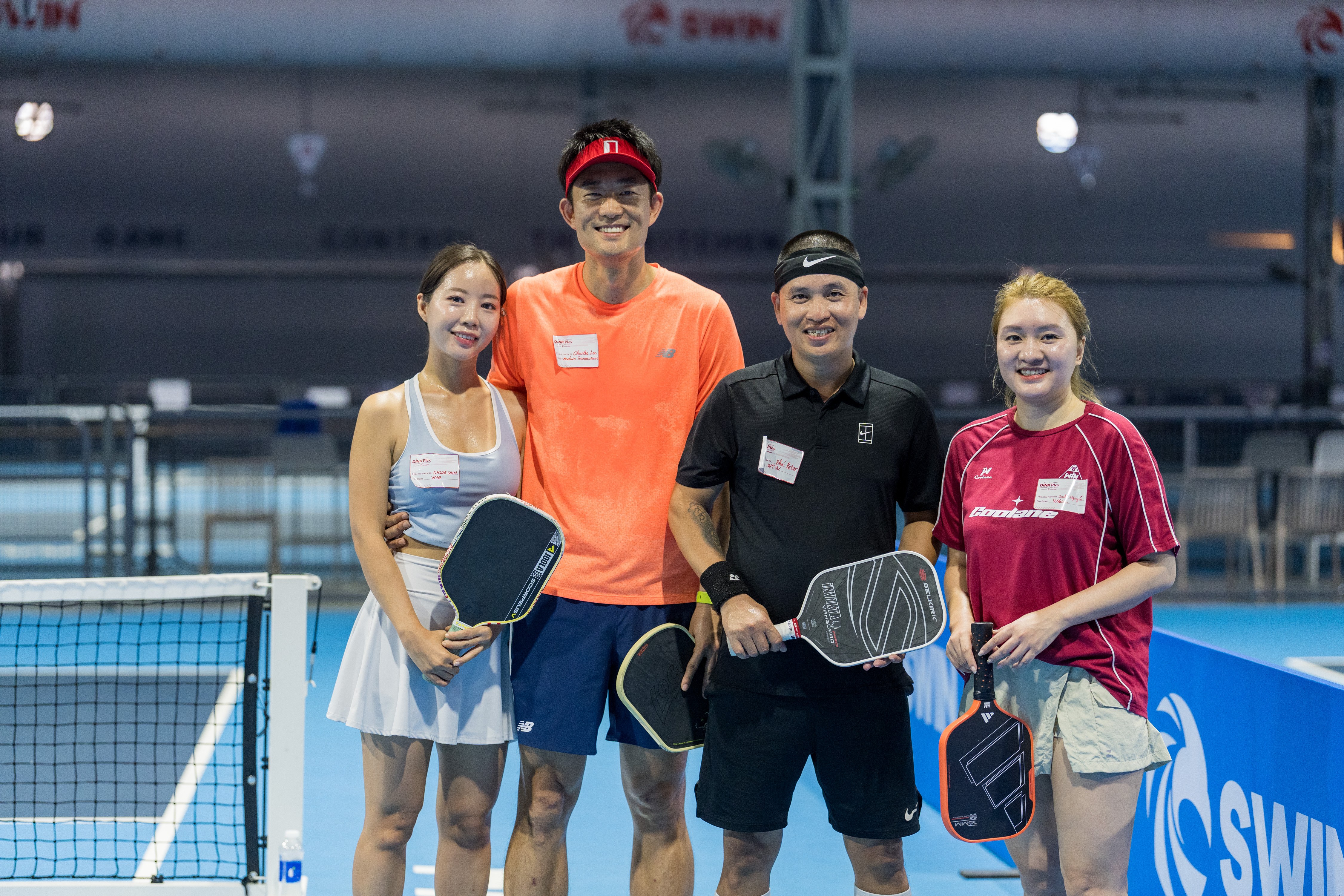 Four pickleball players together on court
